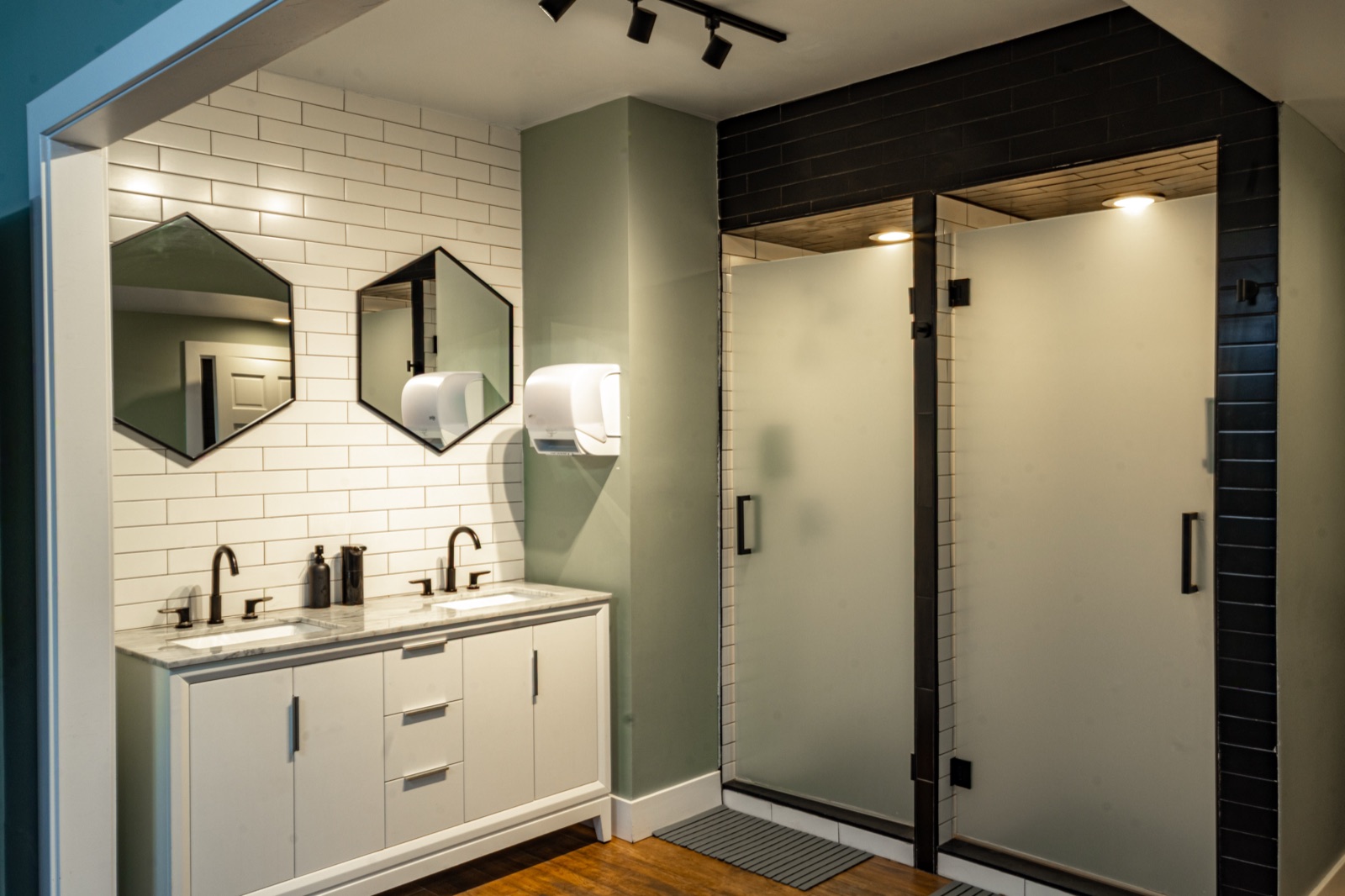 Vanity with double sinks and shower stalls